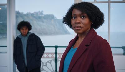 Rakie Ayola as Christine and Jordan Wilks as Connor at a hotel by the sea side in The Pact Season 2.