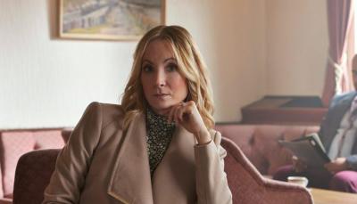 Joanne Froggatt as Sarah, sitting prim and proper-like in her living room in Sherwood