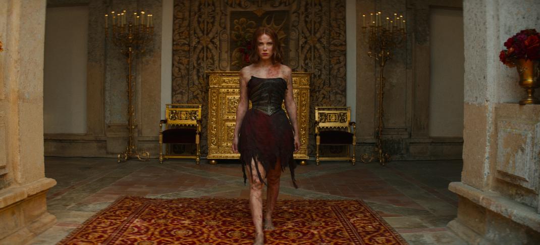 Millie Bobby Brown as Elodie returning to the castle in tatters in Damsel.